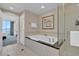 Bright bathroom featuring a soaking tub with modern fixtures and glass-enclosed shower at 135 E Harmon Ave # 1102, Las Vegas, NV 89109