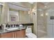 Features a glass shower door, granite countertop, and large mirror at 135 E Harmon Ave # 1102, Las Vegas, NV 89109