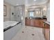 Bathroom showcasing a soaking tub, glass shower, and dual sink vanity at 135 E Harmon Ave # 1102, Las Vegas, NV 89109
