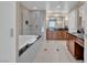 Bathroom showcasing a soaking tub, glass shower, and dual sink vanity at 135 E Harmon Ave # 1102, Las Vegas, NV 89109