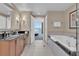 Bathroom featuring modern fixtures, soaking tub, and views of the bedroom at 135 E Harmon Ave # 1102, Las Vegas, NV 89109
