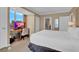 Bright bedroom featuring a large bed, desk and a beautiful city view at 135 E Harmon Ave # 1102, Las Vegas, NV 89109
