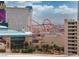 Bright, airy view with rollercoaster and city buildings in the background on sunny day at 135 E Harmon Ave # 1102, Las Vegas, NV 89109