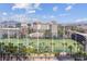 A picturesque golf course featuring palm trees, city views, and clear blue skies at 135 E Harmon Ave # 1102, Las Vegas, NV 89109