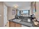 Modern kitchen features custom cabinetry, black countertops, and stainless steel appliances at 135 E Harmon Ave # 1102, Las Vegas, NV 89109
