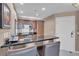 Modern kitchen features custom cabinetry, black countertops, and stainless steel appliances at 135 E Harmon Ave # 1102, Las Vegas, NV 89109
