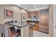 Modern kitchen features custom cabinetry, black countertops, and stainless steel appliances at 135 E Harmon Ave # 1102, Las Vegas, NV 89109