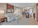 Comfortable living room featuring a sofa, glass coffee table, and view into the kitchen area at 135 E Harmon Ave # 1102, Las Vegas, NV 89109