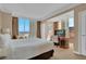 A bright main bedroom with a large window and a work desk at 135 E Harmon Ave # 1102, Las Vegas, NV 89109