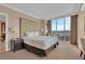 A bright main bedroom with a large window and a work desk at 135 E Harmon Ave # 1102, Las Vegas, NV 89109