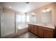 Bathroom featuring a glass shower, bathtub, dual vanity, and modern fixtures at 1405 Gilbert Creek Ave, North Las Vegas, NV 89031