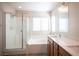 Bathroom featuring a glass shower, bathtub, dual vanity, and modern fixtures at 1405 Gilbert Creek Ave, North Las Vegas, NV 89031