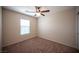 Comfortable bedroom with neutral paint, plush carpet, ceiling fan, and a bright window at 1405 Gilbert Creek Ave, North Las Vegas, NV 89031