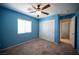 Charming bedroom featuring carpet, a ceiling fan, and a window for natural light at 1405 Gilbert Creek Ave, North Las Vegas, NV 89031