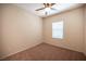 Neutral bedroom featuring a ceiling fan, a window with blinds, and carpeted floors at 1405 Gilbert Creek Ave, North Las Vegas, NV 89031