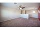 Open bonus room showcasing neutral walls, carpet flooring, and a ceiling fan for comfort at 1405 Gilbert Creek Ave, North Las Vegas, NV 89031