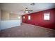 Spacious bonus room featuring plush carpeting, a ceiling fan, and natural light from multiple windows at 1405 Gilbert Creek Ave, North Las Vegas, NV 89031