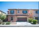 Inviting two-story home featuring a charming facade, well-maintained landscaping, and a convenient two-car garage at 1405 Gilbert Creek Ave, North Las Vegas, NV 89031