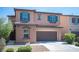 Charming home featuring a well-manicured lawn, two-car garage, and tasteful exterior details at 1405 Gilbert Creek Ave, North Las Vegas, NV 89031