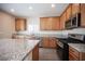 Updated kitchen featuring granite counters, stainless appliances and tile flooring at 1405 Gilbert Creek Ave, North Las Vegas, NV 89031