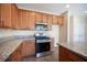 Kitchen features stainless steel appliances, granite countertops, and wood cabinets at 1405 Gilbert Creek Ave, North Las Vegas, NV 89031