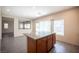 Kitchen island with a granite countertop, wooden cabinets, and tile flooring at 1405 Gilbert Creek Ave, North Las Vegas, NV 89031