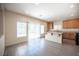 Well-lit kitchen with granite countertops, wood cabinets and stainless steel appliances at 1405 Gilbert Creek Ave, North Las Vegas, NV 89031
