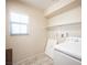 Functional laundry room with shelving, washer hookups, and a window for natural light at 1405 Gilbert Creek Ave, North Las Vegas, NV 89031