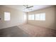 A light filled room with carpet, ceiling fan, and tile floors at 1405 Gilbert Creek Ave, North Las Vegas, NV 89031