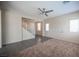 Bright living room with a staircase, large windows, and neutral walls at 1405 Gilbert Creek Ave, North Las Vegas, NV 89031
