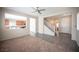 Inviting living room featuring neutral tones, carpeted area and views into the kitchen at 1405 Gilbert Creek Ave, North Las Vegas, NV 89031