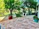 Backyard featuring a built-in grill, stone patio, and view of a pond at 1915 Hazeltine Ct, Henderson, NV 89074