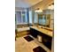 Bright bathroom with double vanity, soaking tub, and separate glass shower at 1915 Hazeltine Ct, Henderson, NV 89074