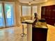 Kitchen with stainless steel appliances, a tile floor, and dark wood cabinets at 1915 Hazeltine Ct, Henderson, NV 89074