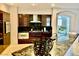 A gourmet kitchen with stainless steel appliances, dark wood cabinets, and an open concept design at 1915 Hazeltine Ct, Henderson, NV 89074