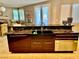 Close-up view of kitchen island featuring a large stainless sink and dark wood cabinets with stainless hardware at 1915 Hazeltine Ct, Henderson, NV 89074