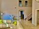 Open-concept living area featuring tile floors and a two-story staircase at 1915 Hazeltine Ct, Henderson, NV 89074
