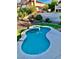 Beautiful backyard pool and spa with lush landscaping, surrounded by well-maintained garden at 1915 Hazeltine Ct, Henderson, NV 89074