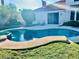 Backyard pool with a tanning ledge, attached spa, and patio furniture at 1915 Hazeltine Ct, Henderson, NV 89074