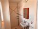 Bathroom featuring a shower, toilet, a sink with a faucet, and a brown framed mirror at 212 Hinkle St, Las Vegas, NV 89107