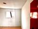 Bedroom featuring a window, an outlet and a red door at 212 Hinkle St, Las Vegas, NV 89107