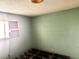 Bedroom featuring carpeted floor, an outlet, and an air conditioner unit by the window at 212 Hinkle St, Las Vegas, NV 89107