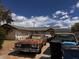 House exterior featuring a driveway with multiple cars parked in front and some trash bins at 212 Hinkle St, Las Vegas, NV 89107