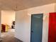 Hallway featuring two doors of different colors at the end and an entrance to the living room to the left at 212 Hinkle St, Las Vegas, NV 89107