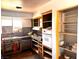 Kitchen featuring an old sink, cabinetry with marble effect countertops, oven, dishwasher and empty shelves at 212 Hinkle St, Las Vegas, NV 89107