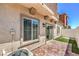 A cozy backyard features faux grass, a brick patio, and a white fence for privacy at 219 Cordelia Cove Ave # 513, Henderson, NV 89011