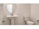 Clean half-bathroom featuring a pedestal sink, toilet, and white walls at 219 Cordelia Cove Ave # 513, Henderson, NV 89011