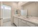 Bright bathroom featuring a double sink vanity, large mirror, and a separate bathtub and shower area at 219 Cordelia Cove Ave # 513, Henderson, NV 89011