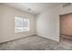 Cozy bedroom with plush gray carpet, a window with blinds, and neutral wall paint at 219 Cordelia Cove Ave # 513, Henderson, NV 89011