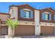 Attractive townhouse featuring two-car garages, brown trim, and well-maintained landscaping at 219 Cordelia Cove Ave # 513, Henderson, NV 89011